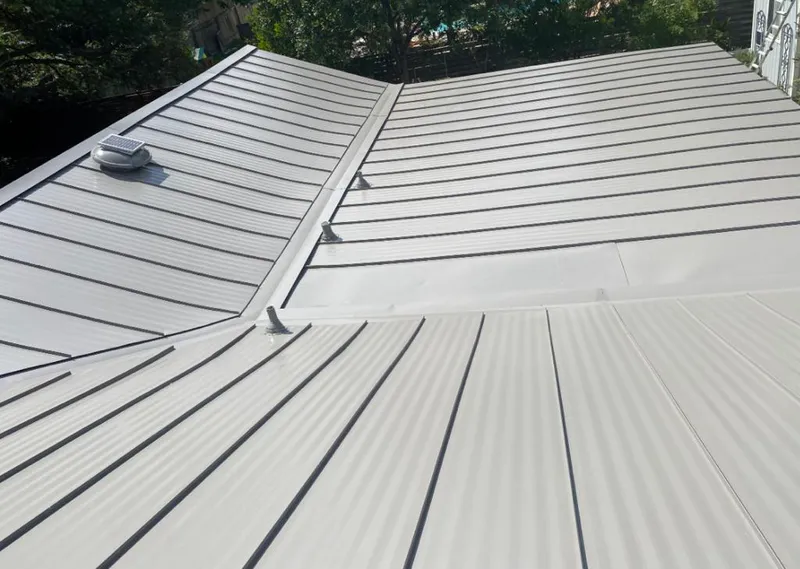 Solar attic fan installed on a metal roof for Roof Ventilation in Orion